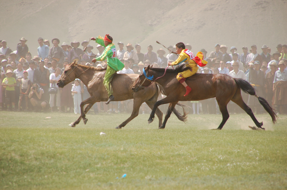 2 rider boys riding & racing in the local naadam festival