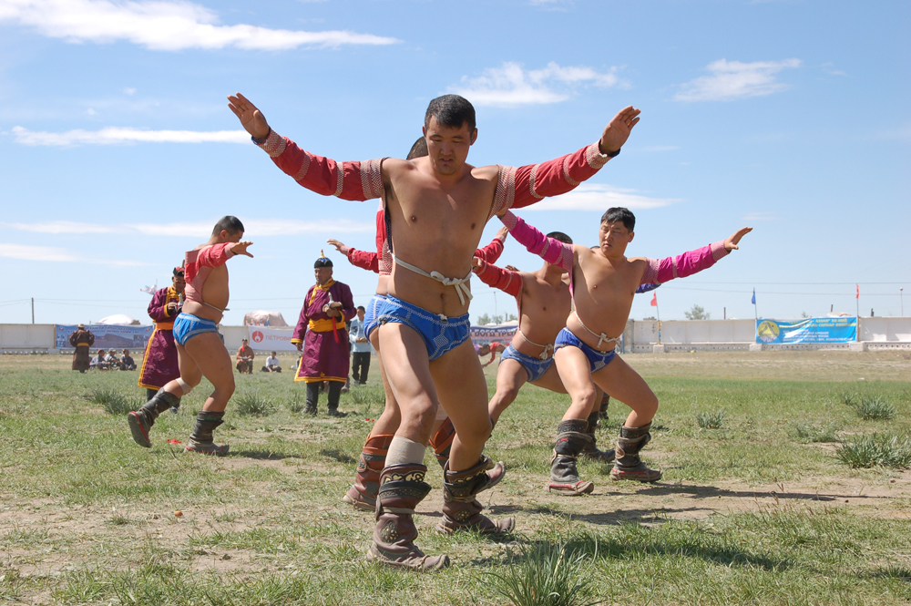 mongolian wrestlers are doing ritual before wrestle at Naadam Festival
