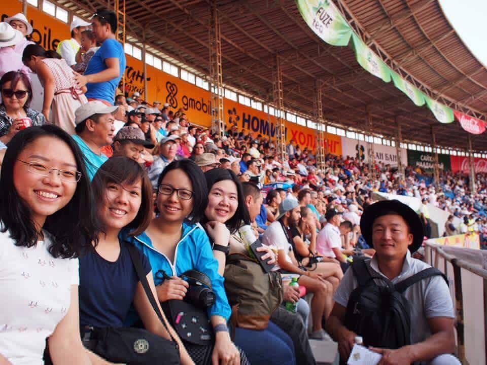 Young customers from Malaysia watch the opening ceremony of the festival at the central stadium of Ulaanbaatar