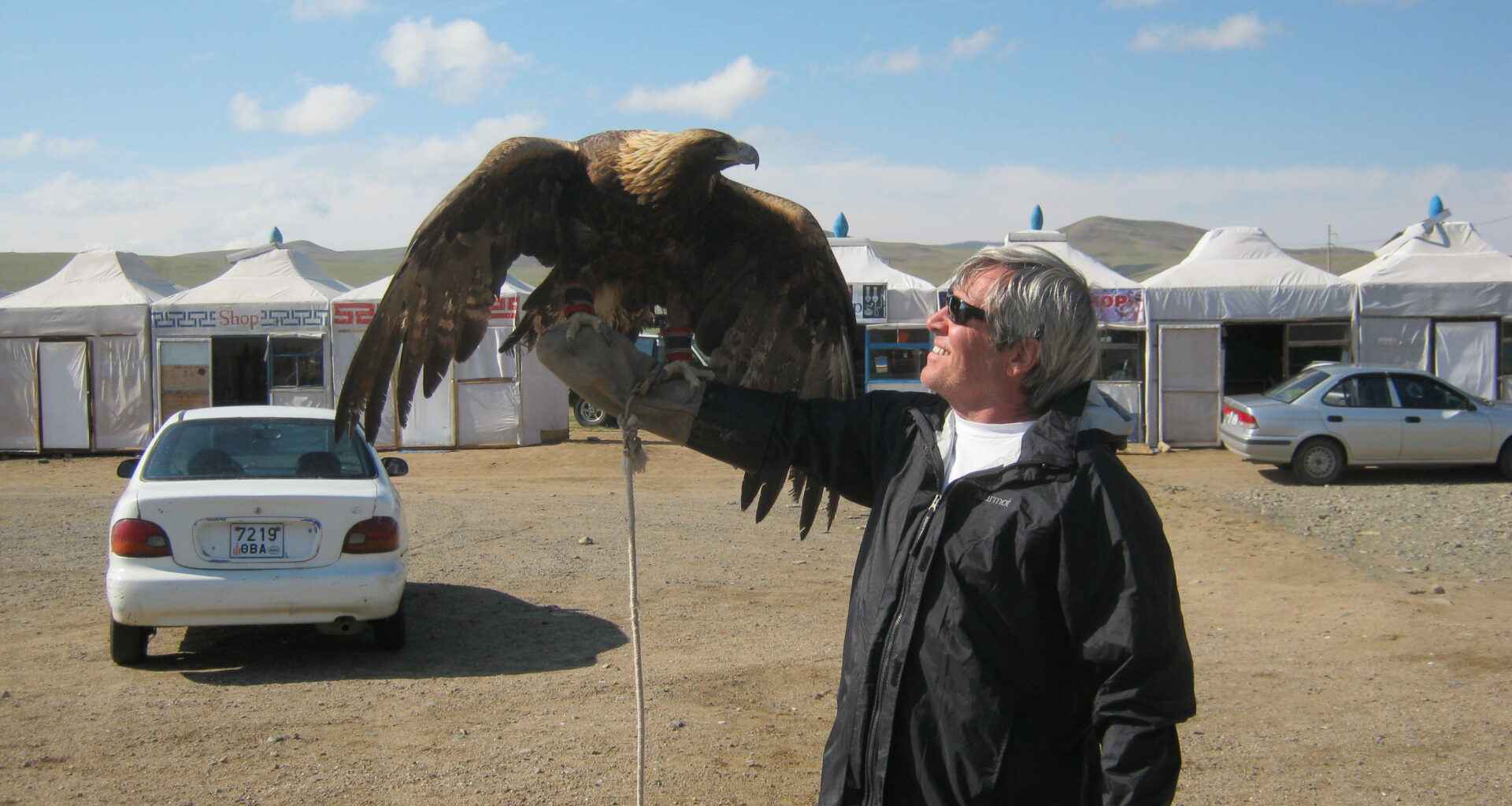 A customer from USA takes a photo with an eagle